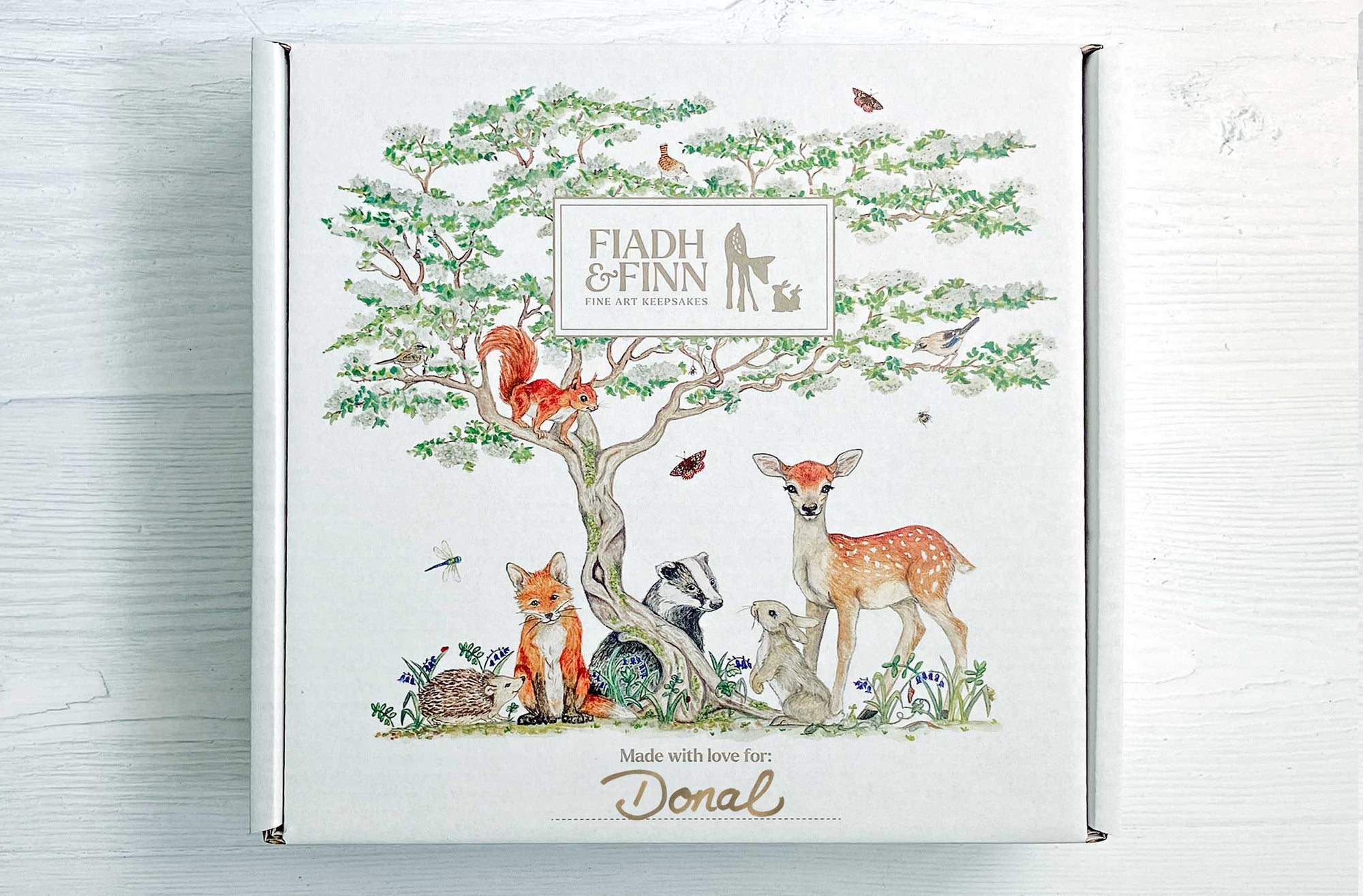 Branded Fiadh&Finn personalised gift box with woodland animals design. Handwritten name Donal on the box.